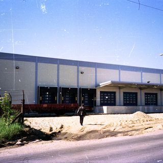 Industrial building under construction with a person nearby.