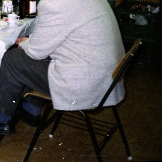 Group seated at a table in a room with a projector.