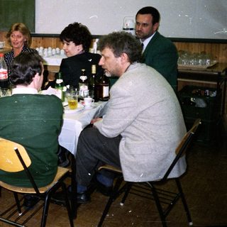 Group seated at a table in a room with a projector.