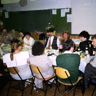 Group seated at a table in a room with a projector.