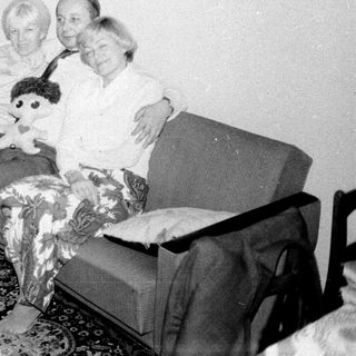 Couple seated on a sofa with a child's doll.