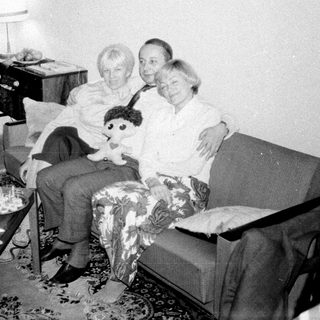 Couple seated on a sofa with a child's doll.