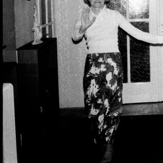 Couple stands in a hallway, appearing to dance.