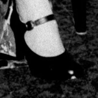 Woman seated with a small, decorated Christmas tree.