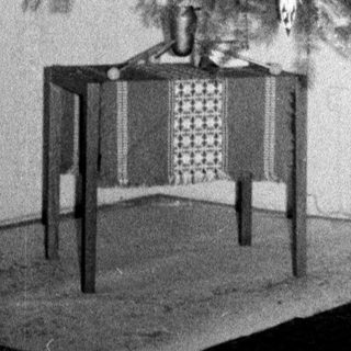 Man stands near a decorated Christmas tree indoors.
