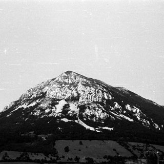 Black and white image of a snow-covered mountain landscape.