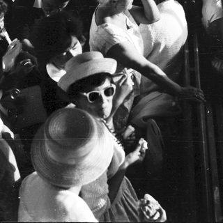 People crowded on a boat, peering over the railing.