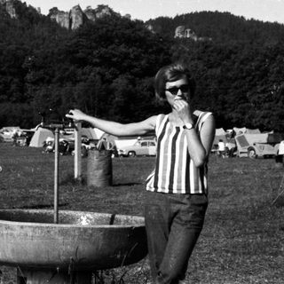 Black and white image of people at a campsite.