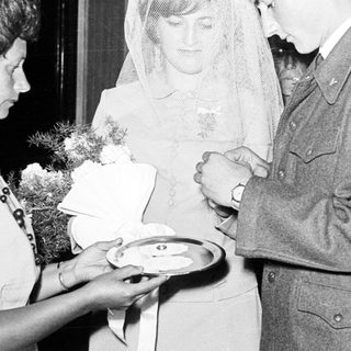Couple receiving refreshments at a wedding reception.
