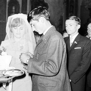 Couple receiving refreshments at a wedding reception.