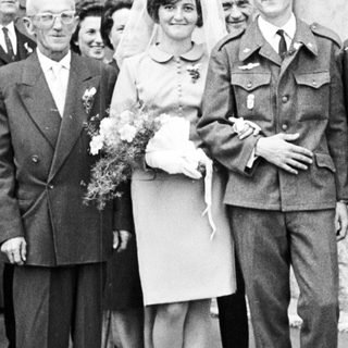 Black and white photo of a wedding party outside.