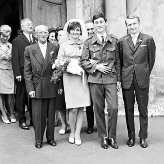 Black and white photo of a wedding party outside.