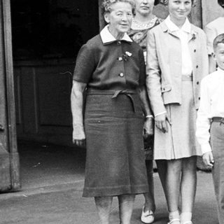 Black and white photo of a wedding party outside.