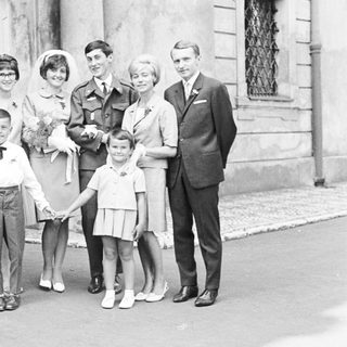 Black and white photo of a wedding party outside.