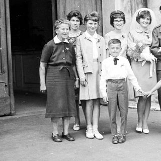 Black and white photo of a wedding party outside.