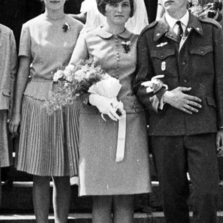 Black and white photo of a wedding party on steps.