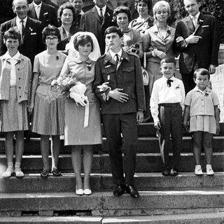 Black and white photo of a wedding party on steps.