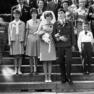 Black and white photo of a wedding party on steps.