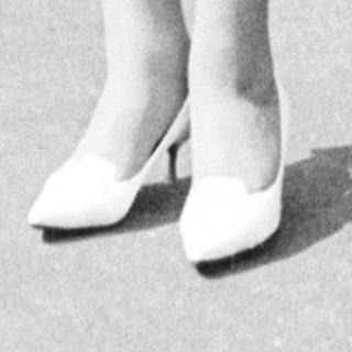 Black and white photo of a bride standing outdoors.