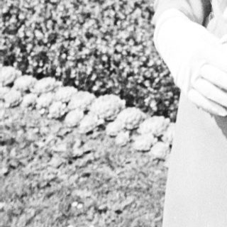 Black and white photo of a bride holding flowers.