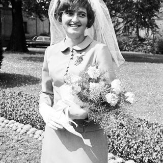 Black and white photo of a bride holding flowers.