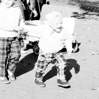 Black and white photo of a family on a street.