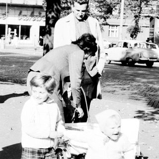 Black and white photo of a family on a street.