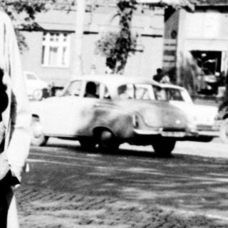 Black and white photo of a family on a street.