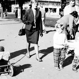 Black and white photo of a family on a street.