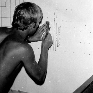 Man examines a complex electrical diagram or schematic.