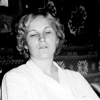 Here's a brief summary of the image: Black and white portrait of a woman with short hair.