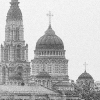 Black and white image of a cathedral and city street.