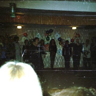 Wedding ceremony with bride and groom on stage.