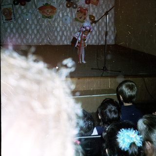 Magician performing puppet show with smoke effect.