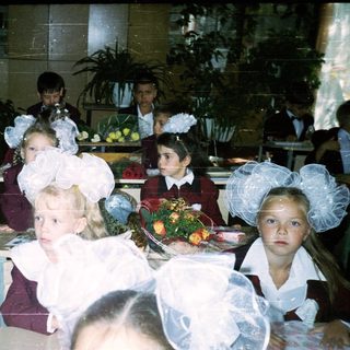 Schoolchildren in formal attire at a celebration.