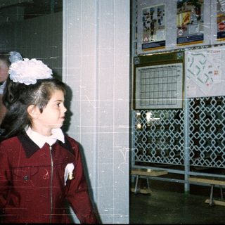 School hallway with road safety posters and student in uniform.