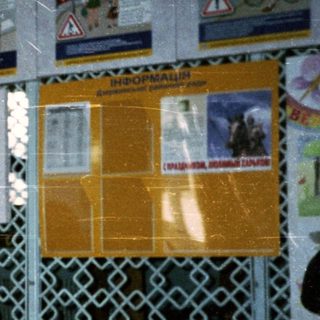 School hallway with road safety posters and student in uniform.