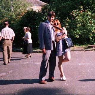 People walking in a park on a sunny day.