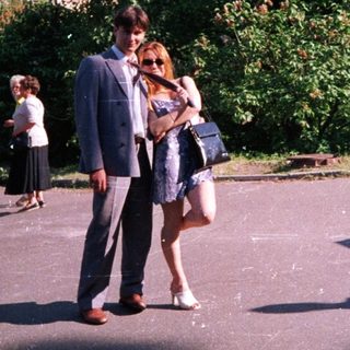 People walking in a park on a sunny day.