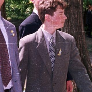 Young men in formal attire walking outdoors.