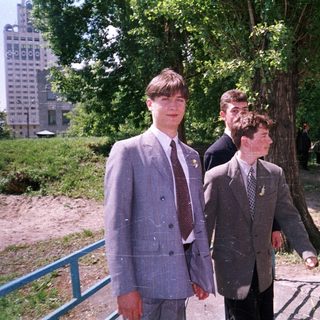 Young men in formal attire walking outdoors.
