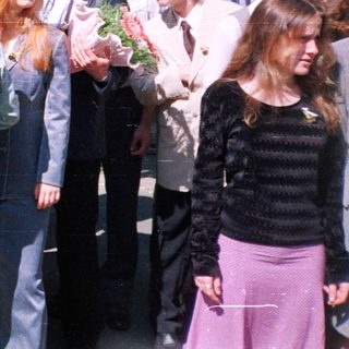 Group of students at outdoor graduation ceremony.