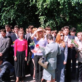 Group of students at outdoor graduation ceremony.