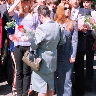 Group of students at outdoor graduation ceremony.