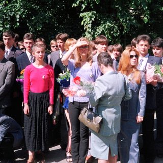 Group of students at outdoor graduation ceremony.