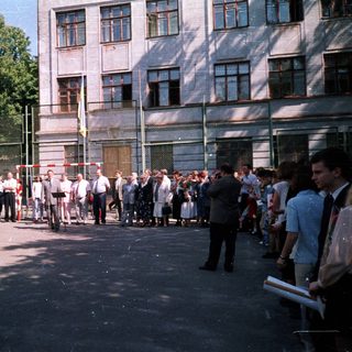 People queuing outside a building during daytime.