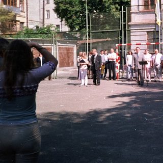 People queuing outside a building during daytime.