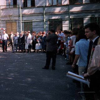 People queuing outside a building during daytime.