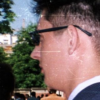 People standing outdoors in formal attire.