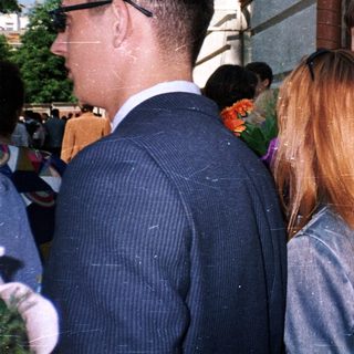 People standing outdoors in formal attire.